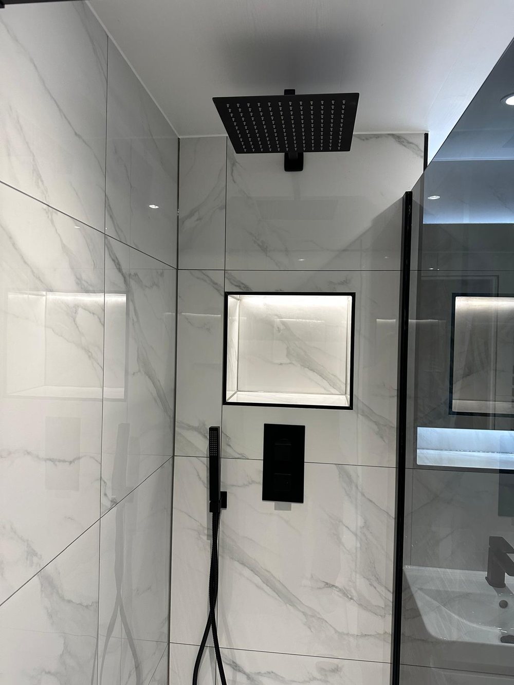 Marble effect shower with a lit niche