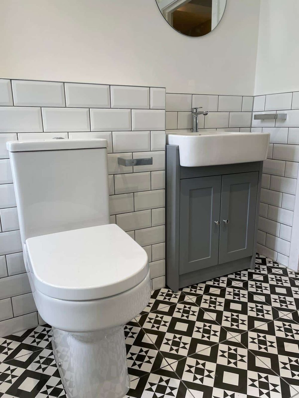 Metro tiles with a grey traditional vanity unit